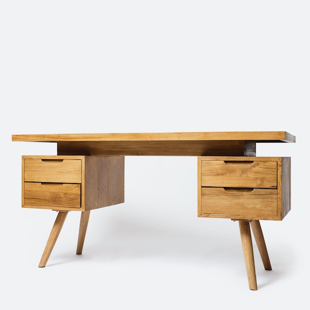 A Wooden Table with Drawers on a white surface