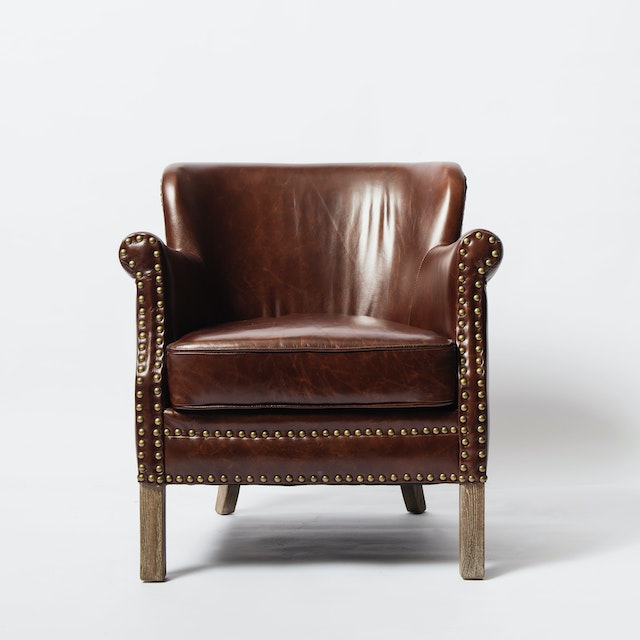 A Brown Leather Chair on a White surface