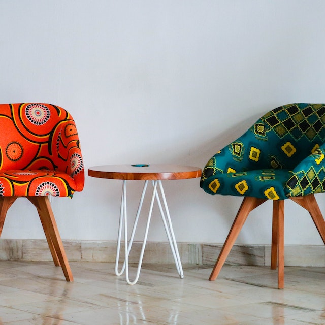 Assorted-color padded chairs near side table